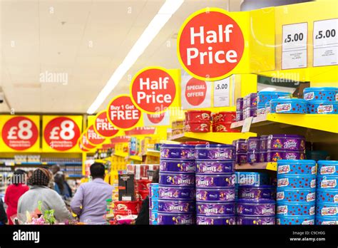 Half price and special offers signs at Tesco Extra supermarket Stock Photo - Alamy