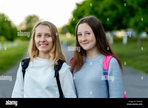Two Girl Friends Schoolgirl Girls Rest After School Summer In Nature Behind Backpacks The