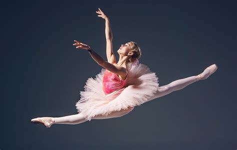 Beautiful Female Ballet Dancer On A Grey Background Ballerina Is Wearing Pink Tutu And Pointe