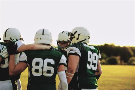 American Football Players In A Huddle During Practice Stock Image