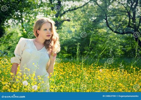 Beautiful Girl In Nature In A Field Of Flowers Stock Photo Image Of