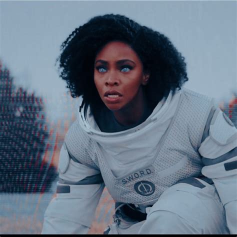 A Woman In An Astronaut Suit Is Staring Into The Distance With Her Hand