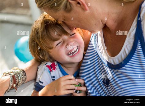 Caucasian Mother Hugging Laughing Son Holding Toy Car Stock Photo Alamy