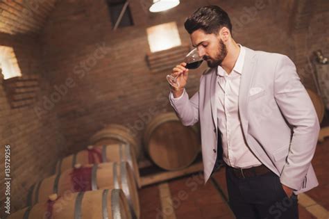 Oenologist Tasting Wines In Cellar Stock Photo And Royalty Free