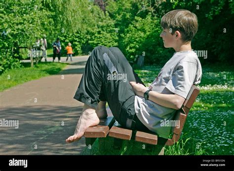Portrait Of A Teenage Boy Sitting On A Bench In A Park Stock Photo Alamy