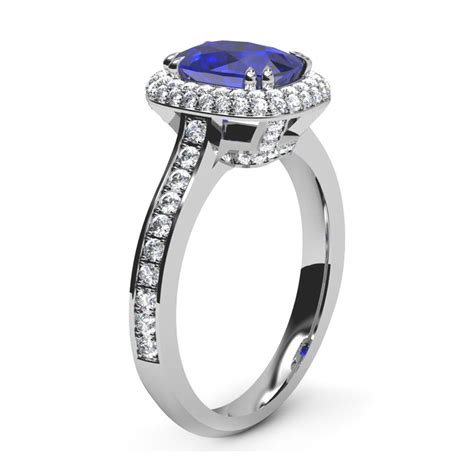 The cushion cut resembles a pillow and has an antique feel and a distinctive, romantic appearance. Cushion Cut Blue Sapphire Engagement Ring with Micro Pave Set Halo