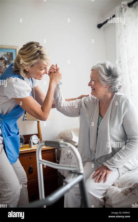 Nurse Helping Senior Woman To Stand Up Stock Photo Alamy