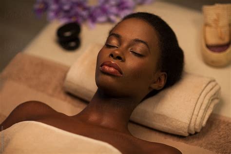 African Woman Lying On A Massage Table By Stocksy Contributor Lumina