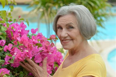 premium photo portrait of a beautiful older woman with flowers