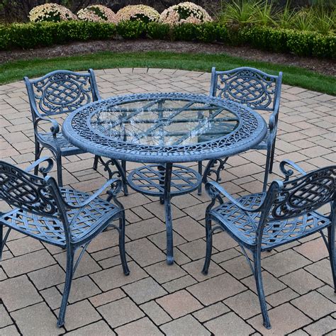 This 7 piece teak wood castle patio dining set includes round to oval extension table, 2 arm chairs and 4 side chairs with cushions. Oakland Living Mississippi 5 Piece Cast Aluminum Patio ...