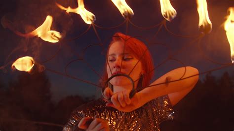 Close Up Portrait Of Lovely Redhead Female Fireshow Performer Juggling With Burning Fans Over