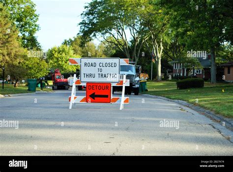 Road Closed To Thru Traffic Detour Construction Sign In A Residential