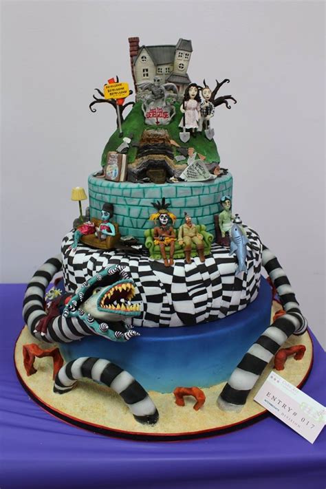 A Multi Layer Cake Decorated With Cartoon Characters