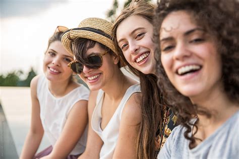 Four Smiling Friends Taking A Selfie Outside By Stocksy Contributor