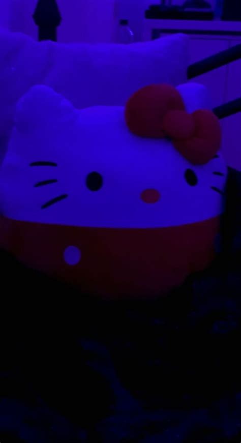 A Large Hello Kitty Pillow Sitting On Top Of A Bed