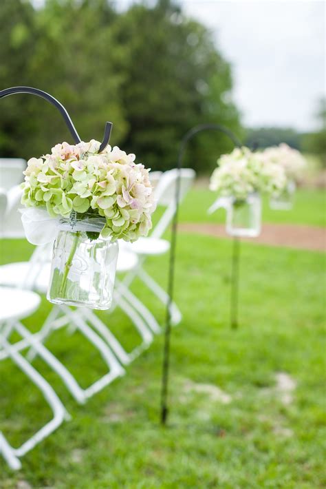 Hanging Mason Jar Aisle Markers Filled With Green Hydrangeas