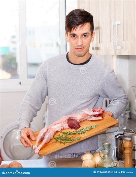 Man Holding Lamb Carcass In Domestic Kitchen Stock Photo Image Of