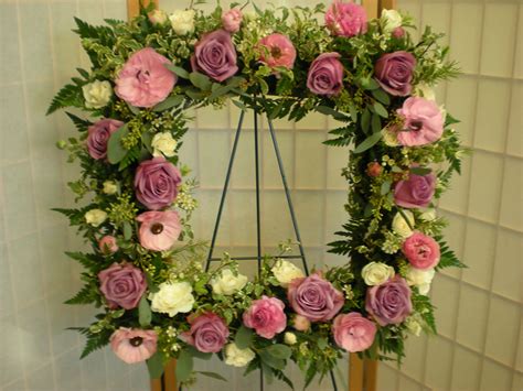 They regularly placed cut flowers in vases. square wreath with roses, anemones, seeded eucalyptus, and ...