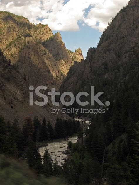 Dark And Narrow Deep Ravine Valley With Roaring River Colorado Stock
