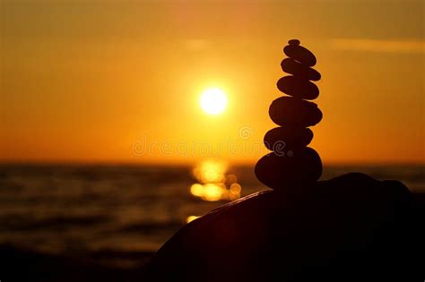 Stack Of Different Stones In Balance At The Beach Sunset Stock Image