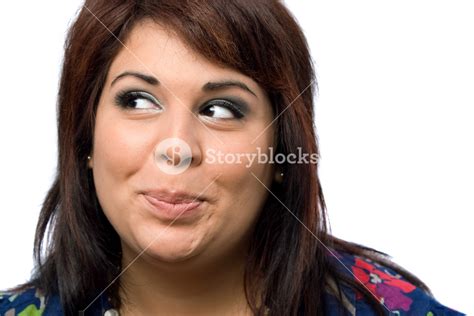 A Hispanic Woman Isolated Over White With A Mischievous Look On Her Face Royalty Free Stock