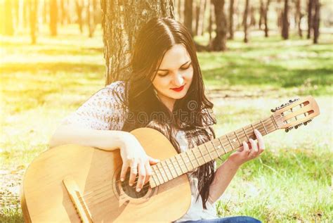 Beautiful Woman Playing An Acoustic Guitar Outdoor Stock Photo Image
