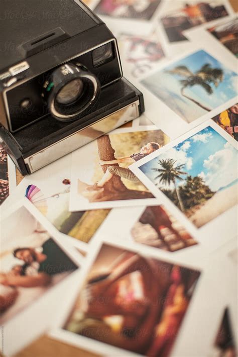 Polaroid Camera And Photos On The Table By Stocksy Contributor