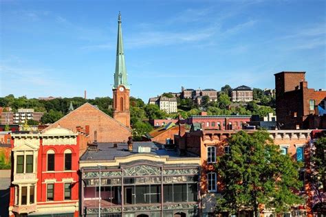 A Collection Of Buildings And A Steeple Under Blue Skies Troy New York