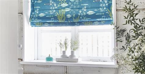Blue Fish Patterned Roman Blinds In White Bathroom 