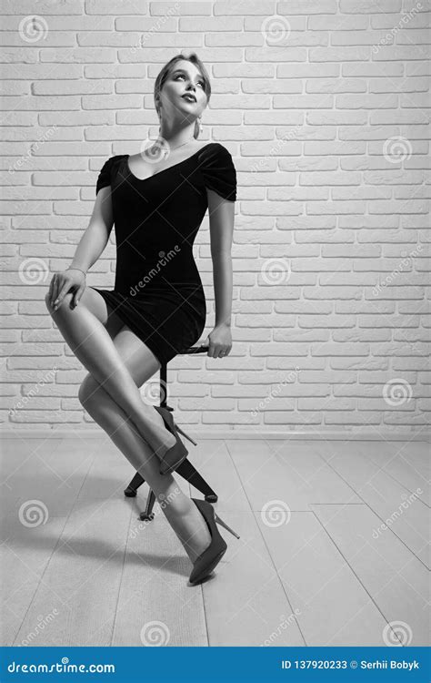 Attractive Model Posing On Chair In Studio Stock Image Image Of