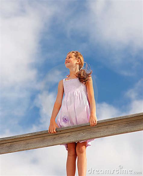 Girl Standing On A Railing Over A Clouded Sky Stock Photo Image Of