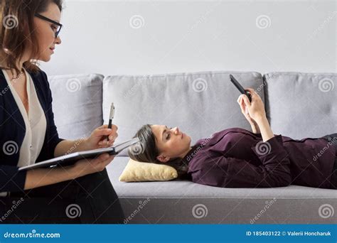 Young Woman At Consultation With Psychologist Female Patient Lying On