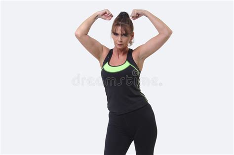 Attractive Middle Aged Woman In Sports Gear Flexing Her Muscles Stock