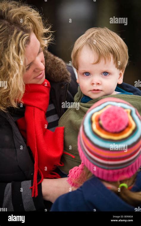 Mom Holding Her Toddler Old Son On Her Hip They Are Both Dressed