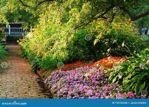 A Path Leads Through A Lovely Colorful Garden Stock Photo Image Of