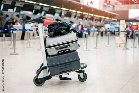 Suitcase Or Baggage With Airport Luggage Trolley In The International