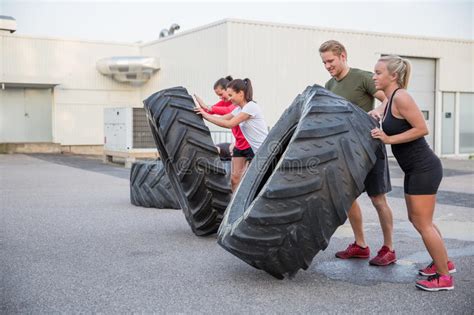 Crossfit Woman Flipping A Huge Tire At Gym Stock Photo Image Of