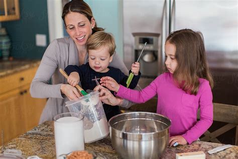 Mother Big Sister And Little Brother Making Cookies In A Kitchen By Stocksy Contributor