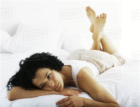 Woman Lying On Stomach Daydreaming Stock Photo Dissolve