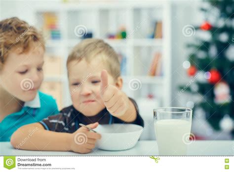 Adorable Little Blond Kids Eating Cereals For Breakfast Or