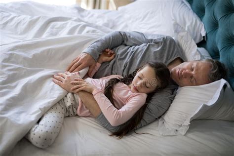 Father And Daughter Sleeping Together On Bed In Bedroom Stock Image Image Of Bonding Life