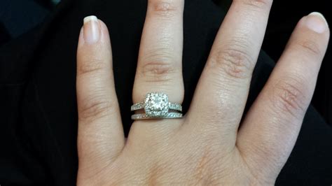 Woman wearing engagement ring on fourth finger. How often do you wear your engagement ring?
