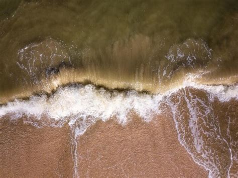 Aerial View Of A Sandy Beach And Sea With Amazing Waves Scenic
