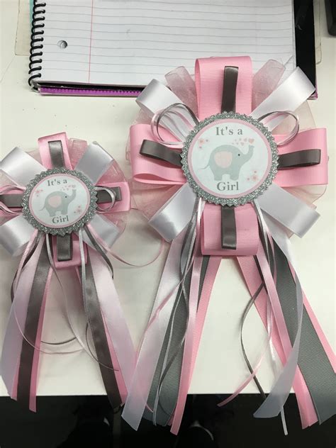 Two Pink And Silver Ribbon Bows With Elephant On The Side Sitting Next