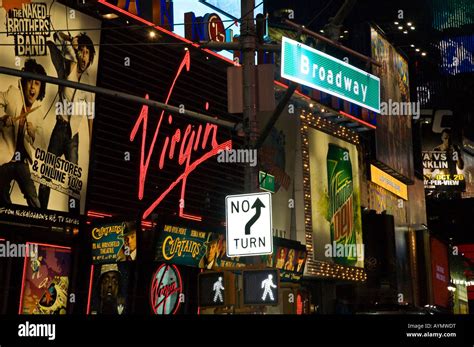 Broadway Street Sign With Neon Light Advertising Banners Behind It