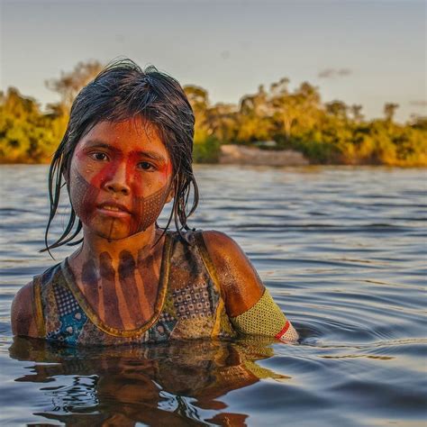 A Woman Is In The Water With Mud On Her Face