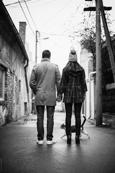 Couple Walking Down The Street By Stocksy Contributor Mosuno Stocksy
