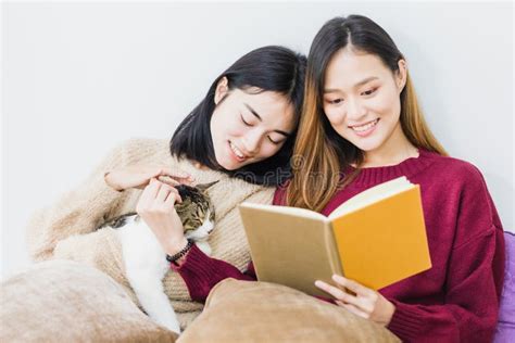 Young Beautiful Asian Women Lesbian Couple Lover Reading Book And