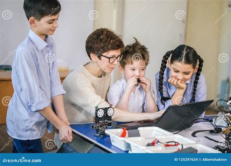 Happy Children Learn Programming Using Laptops On Extracurricular
