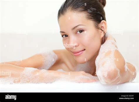Beauty Portrait Of Woman In Bathtub With Bath Foam Smiling Happy Looking Serene At Camera Stock